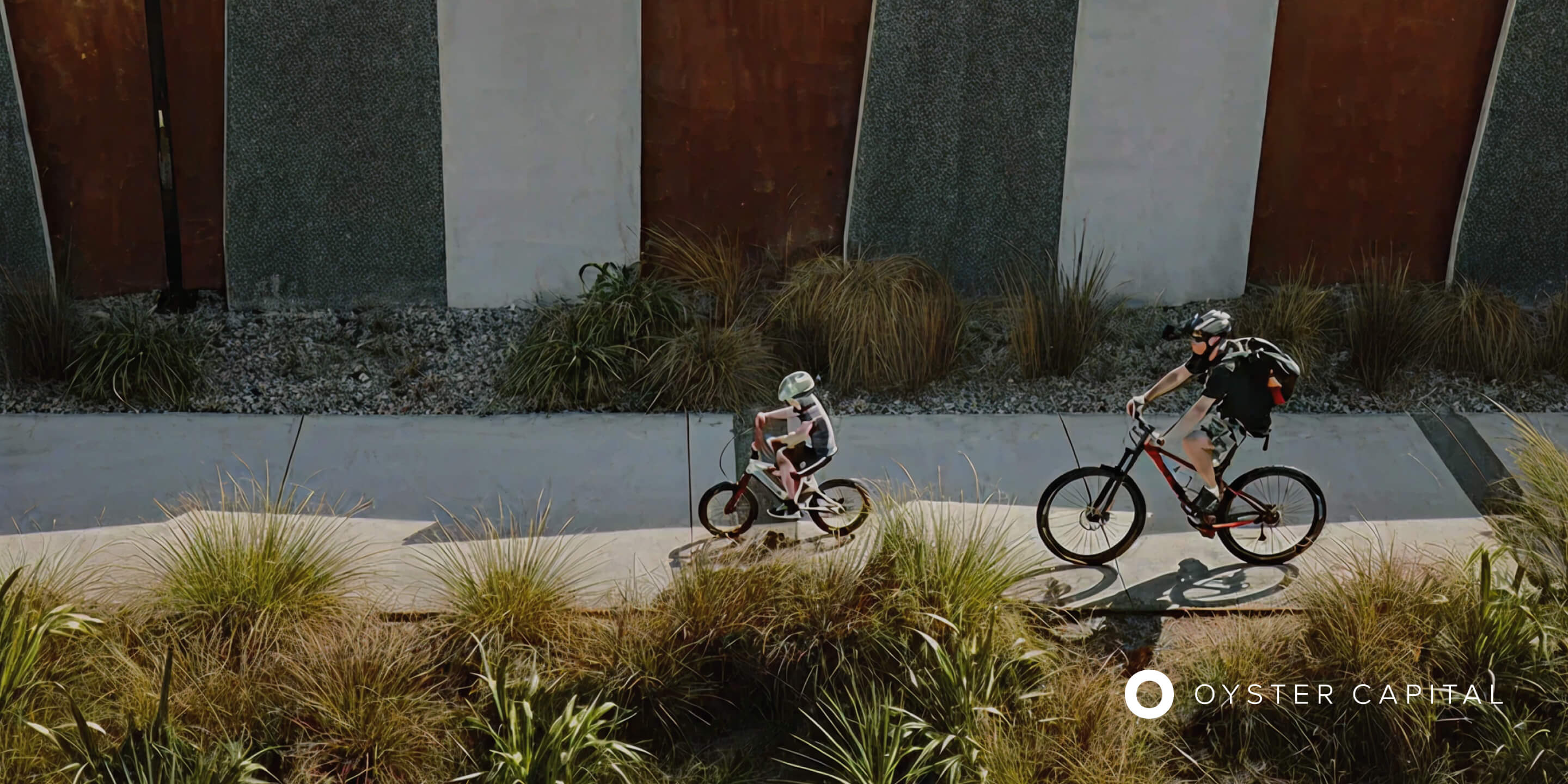 Cyclists travelling through an Oyster Capital development