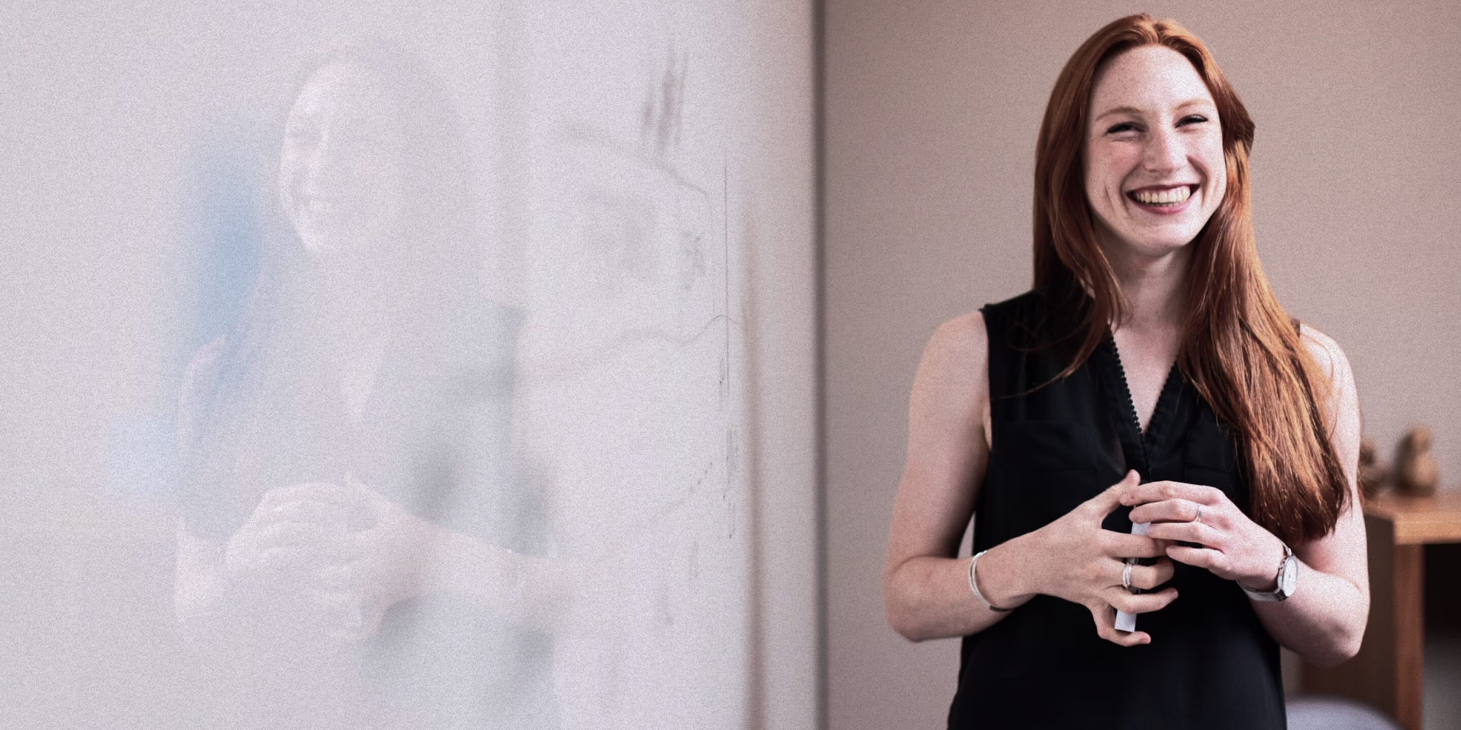 Teacher standing beside a classroom whiteboard